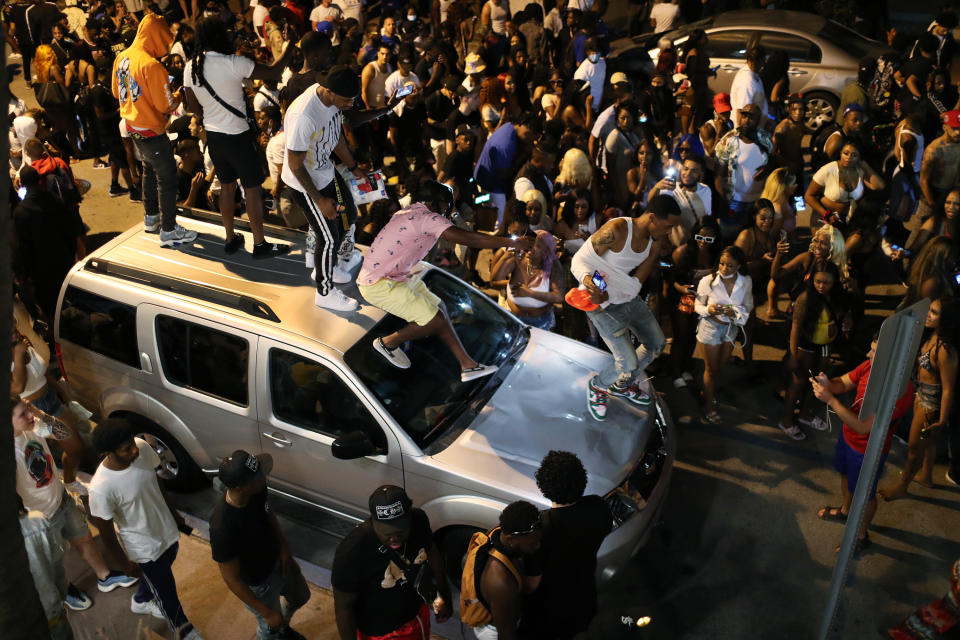 MIAMI BEACH, FLORIDA - MARCH 21: People gather while exiting the area as an 8pm curfew goes into effect on March 21, 2021 in Miami Beach, Florida. College students have arrived in the South Florida area for the annual spring break ritual, prompting city officials to impose an 8pm to 6am curfew as the coronavirus pandemic continues. Miami Beach police have reported hundreds of arrests and stepped up deployment to control the growing spring break crowds. (Photo by Joe Raedle/Getty Images)