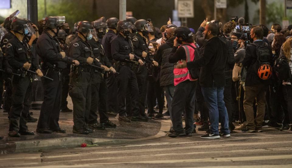 LAPD and a group that had been walking through the streets following a vigil come to a stand still.