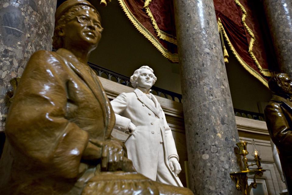 A sculpture of John Gorrie of Florida, inventor of the ice machine, stands next to the popular Rosa Parks in Statuary Hall at the Capitol in Washington, Tuesday, July 2, 2013. A physician, scientist, and inventor, Gorrie is considered the father of refrigeration and air-conditioning; he died impoverished and virtually forgotten in 1855. Among the U.S. Capitol’s many statues which honor the nation’s founders, leaders and legends, the marble figure by scuptor C.A. Pillars, is largely overlooked by thousands of visitors who tour the Capitol daily. (AP Photo/J. Scott Applewhite)