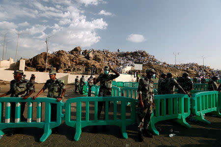 Saudi security officers secure as Muslim pilgrims gather on Mount Mercy on the plains of Arafat during the annual haj pilgrimage, outside the holy city of Mecca, Saudi Arabia August 20, 2018. REUTERS/Zohra Bensemra