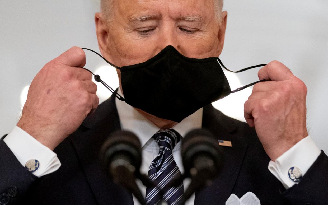 President Joe Biden takes off his mask to speak about the COVID-19 pandemic during his prime-time address from the East Room of the White House this week - AP