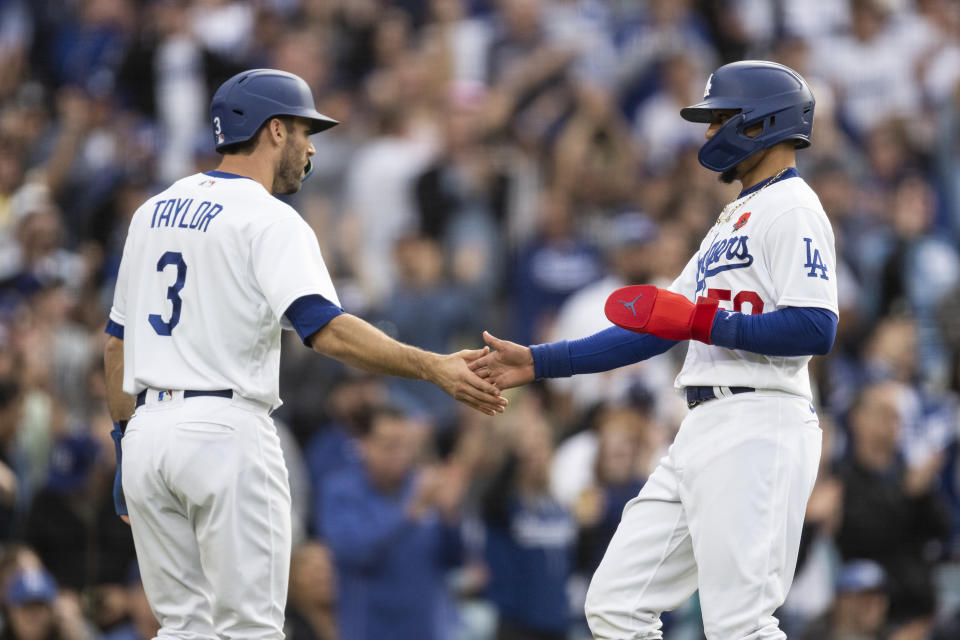 Los Angeles Dodgers' Mookie Betts, right and Chris Taylor celebrate after scoring on a two-run double by Freddie Freeman during the fifth inning of a baseball game against the Washington Nationals in Los Angeles, Monday, May 29, 2023. (AP Photo/Kyusung Gong)