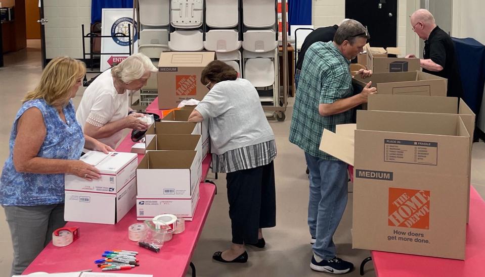 Volunteers from the Family Resource Group prepare care packages for the Company A, 1-182nd Infantry deployed overseas.