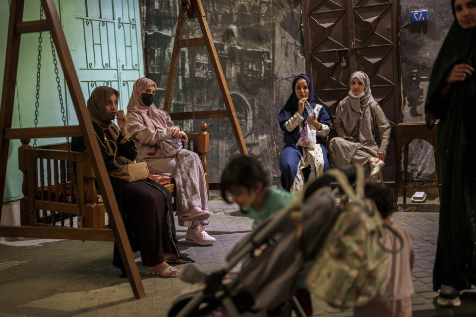 Women gather in a public area in the Al Balad neighborhood of Jeddah, Saudi Arabia, Saturday, Dec 16, 2023. (AP Photo/Manu Fernandez)