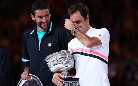 Marin Cilic (L) of Croatia poses with the runners-up trophy and Roger Federer of Switzerland poses with the Norman Brookes Challenge Cup after winning the 2018 Australian Open Men's Singles Final against on day 14 of the 2018 Australian Open at Melbourne Park on January 28, 2018 in Melbourne, Australia - Credit: Getty Images