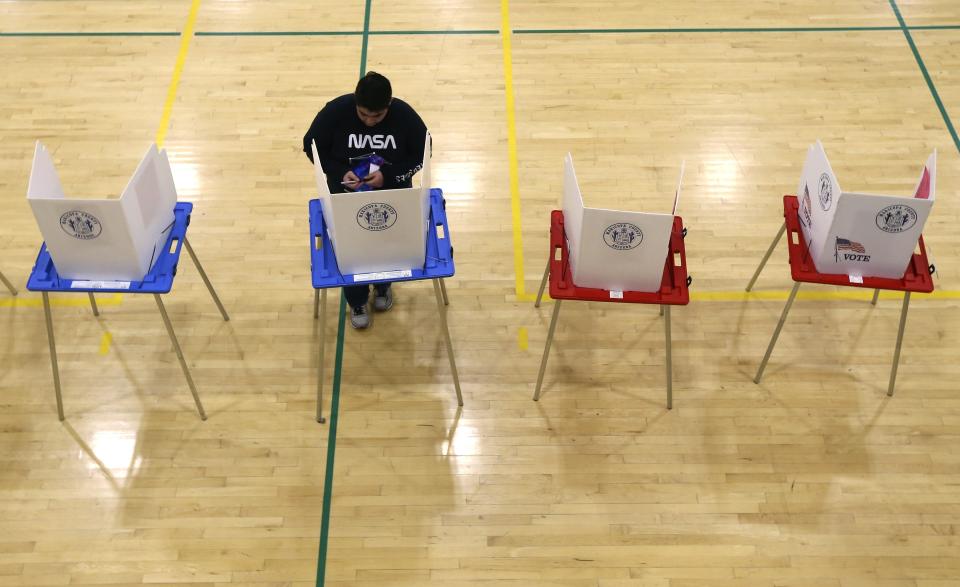 In this March 5, 2020, photo a student votes in a mock Democratic presidential preference election and voter registration drive at Maryvale High School in Phoenix. At the school hundreds of students who will turn 18 before Election Day were registered to vote. (AP Photo/Ross D. Franklin)