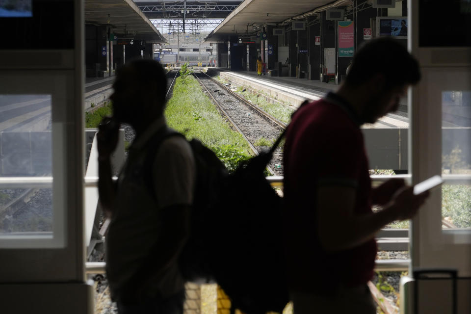 Passengers wait for their trains at Rome's termini central station during a national train strike, Thursday, July 13, 2023. Trenitalia and Italo train workers are on strike to demand better working conditions and training. (AP Photo/Gregorio Borgia)
