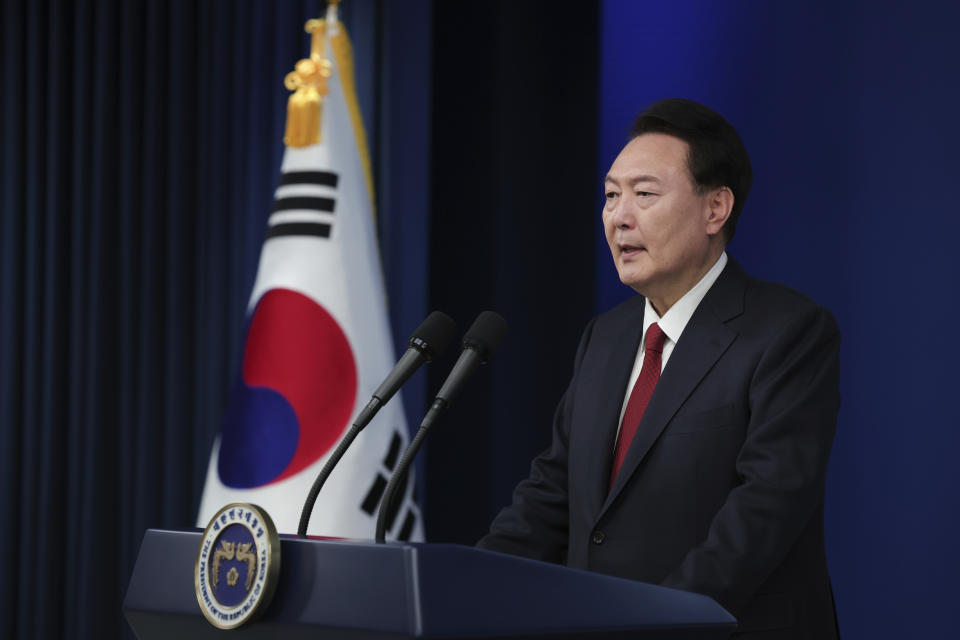 In this photo provided by South Korea Presidential Office, South Korean President Yoon Suk Yeol speaks during his New Year's speech at the presidential office in Seoul, South Korea, Monday, Jan. 1, 2024. (South Korea Presidential Office via AP)