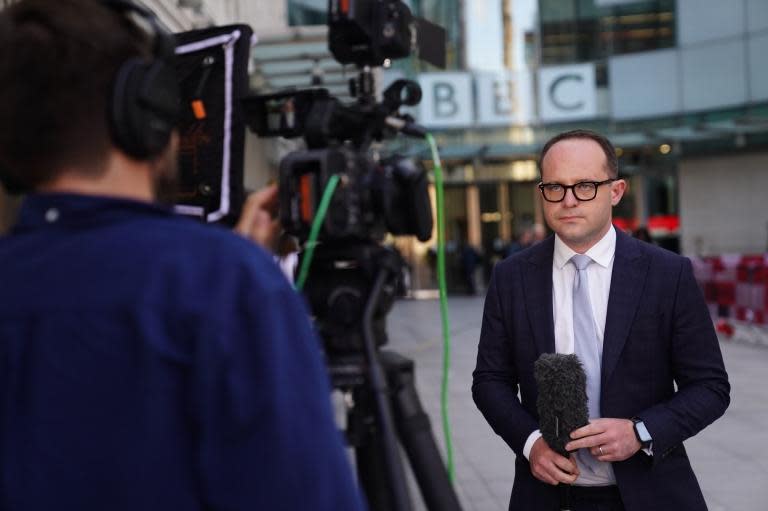 A reporter in front of BBC headquarters