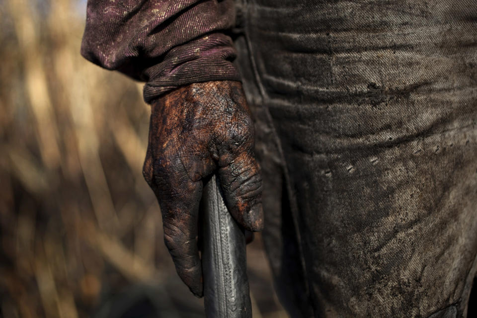 <p>The hand of sugar cane worker Isaias is covered by ash as he works on a field near Retalhuleu, Guatemala. Sugar is Guatemala’s most important agricultural export, making Guatemala the fifth largest sugar exporter in the world, Nov. 26, 2011. The industry employs around 350,000 people, with people migrating from all parts of Guatemala, during the harvest season from October to March. Sugar cane workers earn around 60 quetzales per day, around $8 U.S. (Photo: Rodrigo Abd/AP) </p>