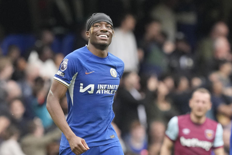 Chelsea's Noni Madueke celebrates after scoring his side's third goal during the English Premier League soccer match between Chelsea and West Ham United at Stamford Bridge stadium in London, England, Sunday, May 5, 2024. (AP Photo/Frank Augstein)