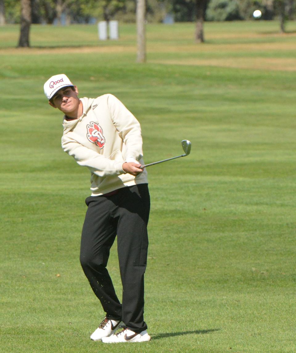 Milbank's Charlie Peery watches his chip head to the No. 1 Red green during the Watertown Boys Golf Invitational on Tuesday, Sept. 24, 2024, at Cattail Crossing Golf Course.