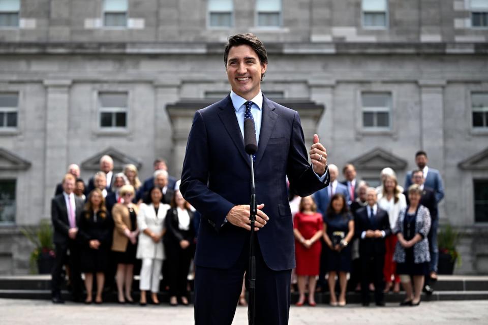 Prime Minister Justin Trudeau gestures towards the federal cabinet as they stand behind him at a media availability after a cabinet shuffle, at Rideau Hall in Ottawa, on Wednesday, July 26, 2023.