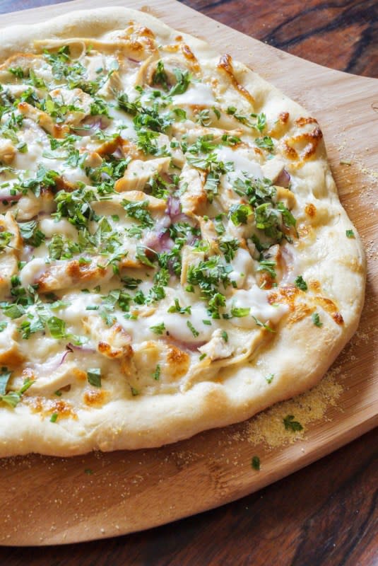 <p>Tara's Multicultural Table</p><p>This white pizza base is a white Parmesan sauce with roasted garlic that's then topped with shredded chicken, red onion and mozzarella.</p><p><strong>Get the recipe: <a href="https://tarasmulticulturaltable.com/white-pizza-with-chicken-and-fresh-herbs/" rel="nofollow noopener" target="_blank" data-ylk="slk:White Pizza with Chicken and Fresh Herbs;elm:context_link;itc:0;sec:content-canvas" class="link ">White Pizza with Chicken and Fresh Herbs</a></strong></p>