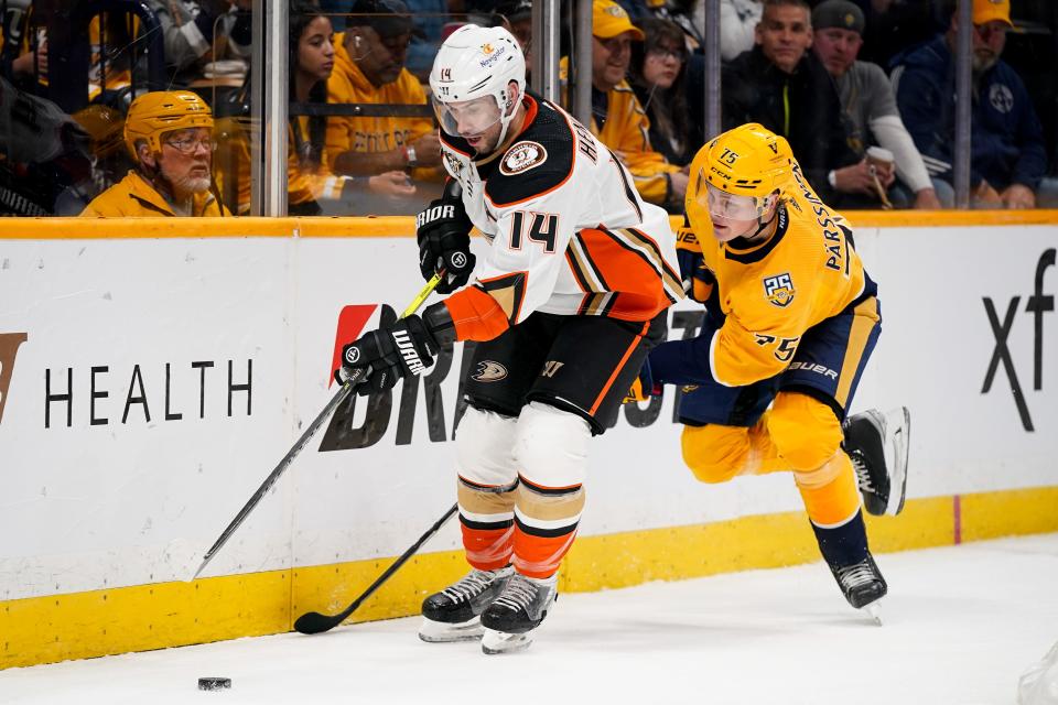 Anaheim Ducks center Adam Henrique (14) battles with Nashville Predators center Juuso Parssinen (75) during the first period at Bridgestone Arena in Nashville, Tenn., Tuesday, Nov. 14, 2023.