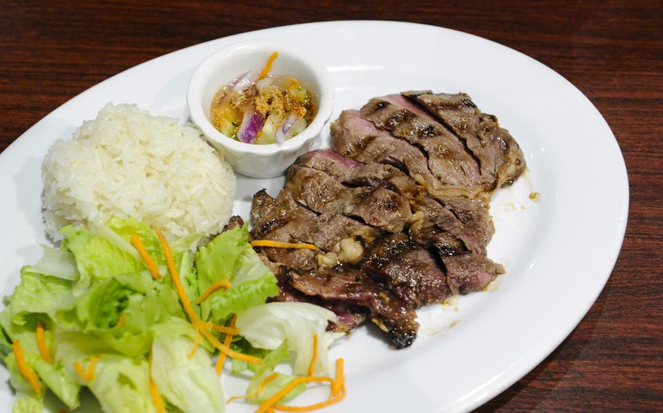 A Thai ribeye steak with rice, salad and sauce is served at the Thai Bistro & Bar on Tuesday, Oct. 24, 2023.