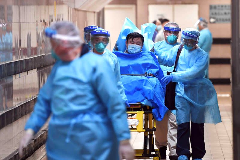 Personal médico transfiere a un paciente de un caso altamente sospechoso de un nuevo coronavirus en el Hospital Reina Isabel en Hong Kong.