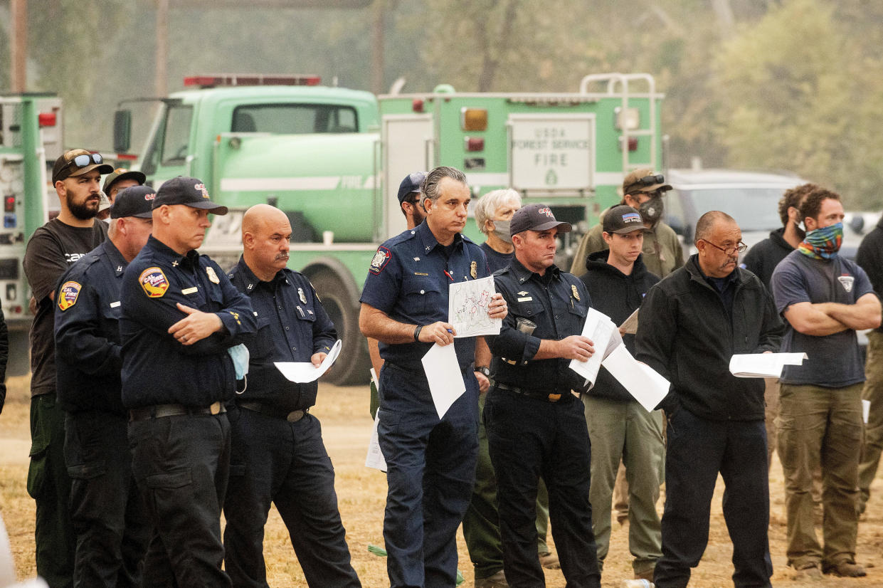 Firefighters attend a morning briefing in the Three Rivers community of Tulare County, Calif., while battling the KNP Complex Fire on Thursday, Sept. 16, 2021. (AP Photo/Noah Berger)