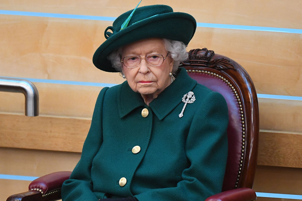 The Queen looking solemn.