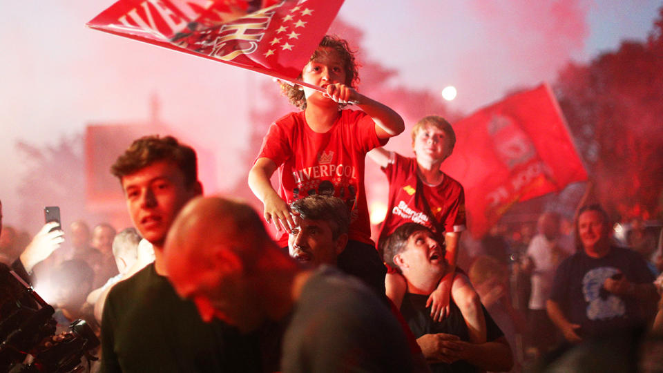 Liverpool fans, pictured here celebrating at Anfield after their Premier League title.