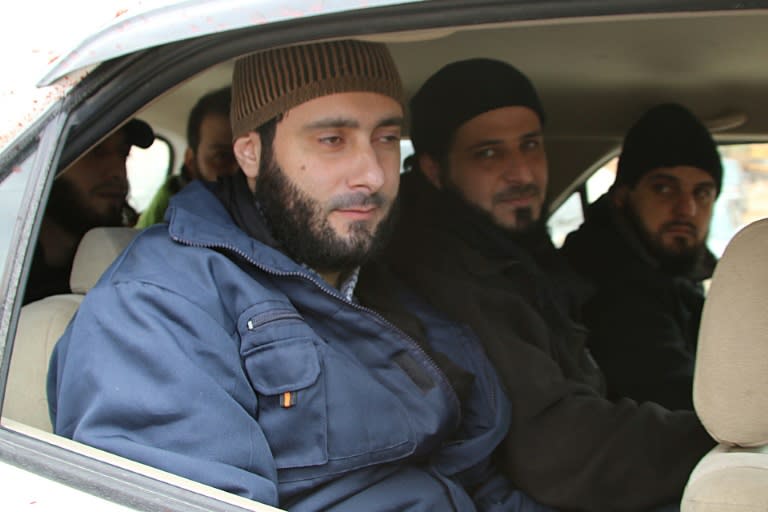 Members of the Lebanese security forces who were kidnapped by jihadist groups from Arsal near the Syrian border last year sit in a Red Cross vehicle moments after their release on December 1, 2015