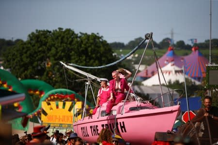 Protestors affiliated with Extinction Rebellion take part in a procession during Glastonbury Festival at Worthy farm in Somerset