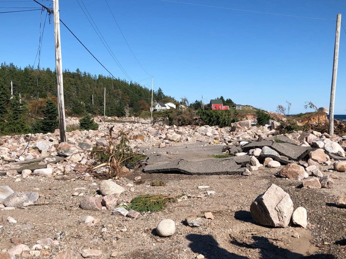 Several hundred metres of New Haven Road, near Neil's Harbour, N.S., crumbled and washed away during Saturday's storm. Area residents say there's nothing left but a rocky beach. (Tom Ayers/CBC - image credit)