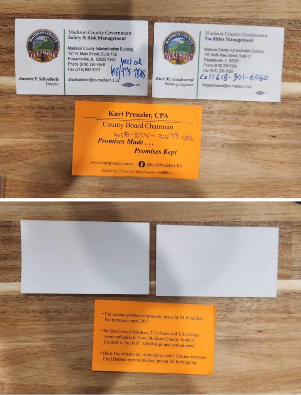 Madison County Board Chairman Kurt Prenzler’s “campaign-style” business cards, as described by the county’s ethic’s adviser, are shown next to examples of official county business cards.