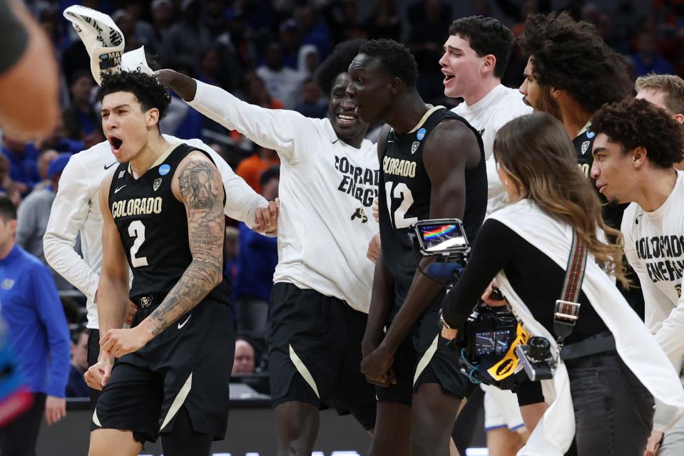 Colorado Buffaloes guard KJ Simpson (2) celebrates with forward Bangot Dak (12) and teammates after defeating the Florida Gators in the first round of the 2024 NCAA Tournament at Gainbridge FieldHouse.
