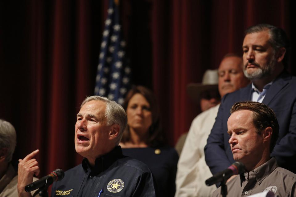 Texas Gov. Greg Abbott speaks during a news conference in Uvalde, Wednesday, as Sen. Ted Cruz, R-Texas, far right, listens.