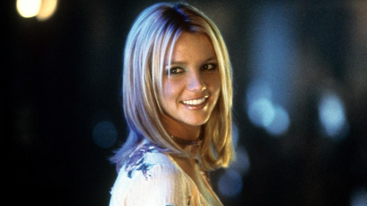  Britney Spears smiling as she looks back in a scene from the film 'Crossroads', 2002. 