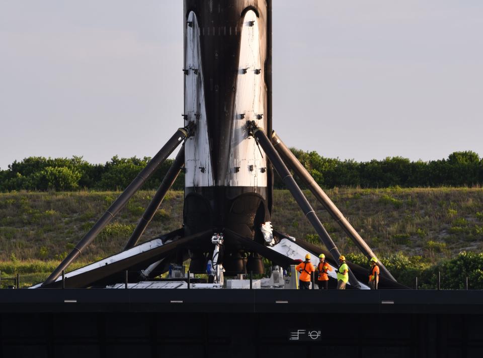 A SpaceX Falcon 9 first-stage booster floats into Port Canaveral just after sunrise in August 2021 aboard the SpaceX drone ship A Shortfall of Gravitas.