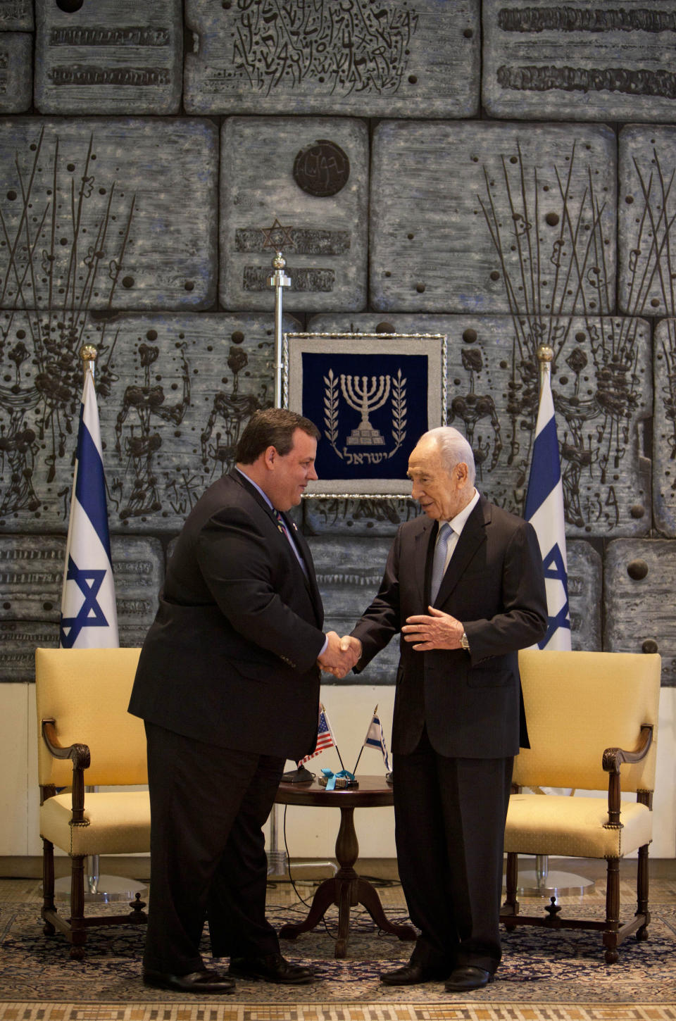 New Jersey Gov. Chris Christie, left, shakes hands with Israeli President Shimon Peres during their meeting at the President's residence in Jerusalem, Tuesday, April. 3, 2012. Christie kicked off his first official overseas trip Monday meeting Israel's leader in a visit that may boost the rising Republican star's foreign policy credentials ahead of November's presidential election.(AP Photo/Oded Balilty)