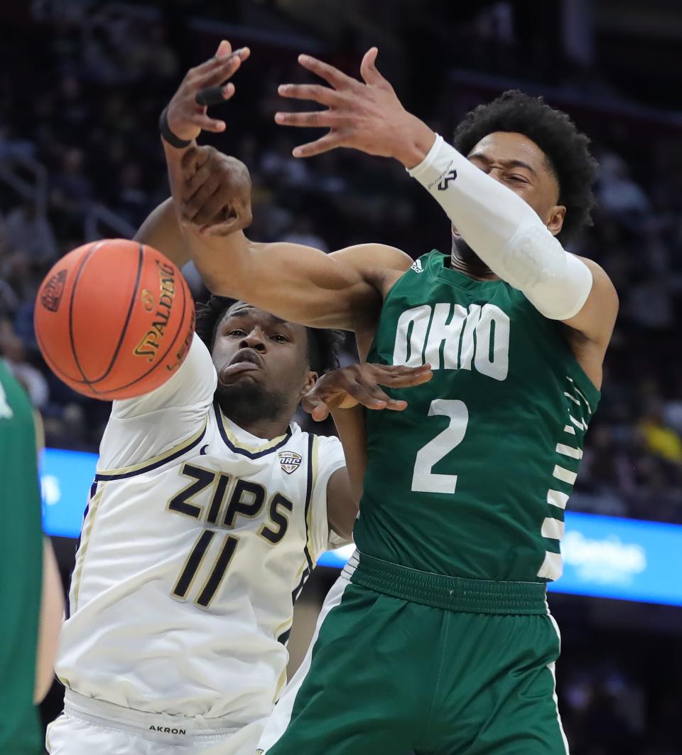 Akron Zips forward Sammy Hunter (11) and Ohio Bobcats guard Miles Brown (2) fight for a rebound during the first half of an NCAA college basketball game in the semifinals of the Mid-American Conference Tournament at Rocket Mortgage FieldHouse, Friday, March 15, 2024, in Cleveland, Ohio.
