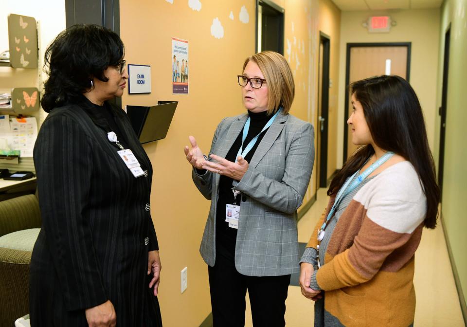 Amy Herbst, middle, Children’s Wisconsin's vice president of mental and behavioral health, speaks with Stephany Pruitt, a psychotherapist, and Lynn Chowdhury, a pediatrician, at Children’s Next Door Pediatrics Primary Care.