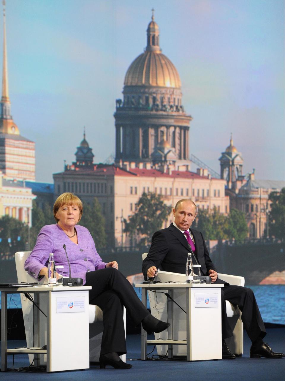 Russian President Vladimir Putin, right, and German Chancellor Angela Merkel attend the economic forum in St. Petersburg, Russia, Friday, June 21, 2013. (AP Photo/RIA-Novosti, Mikhail Klimentyev, Presidential Press Service)