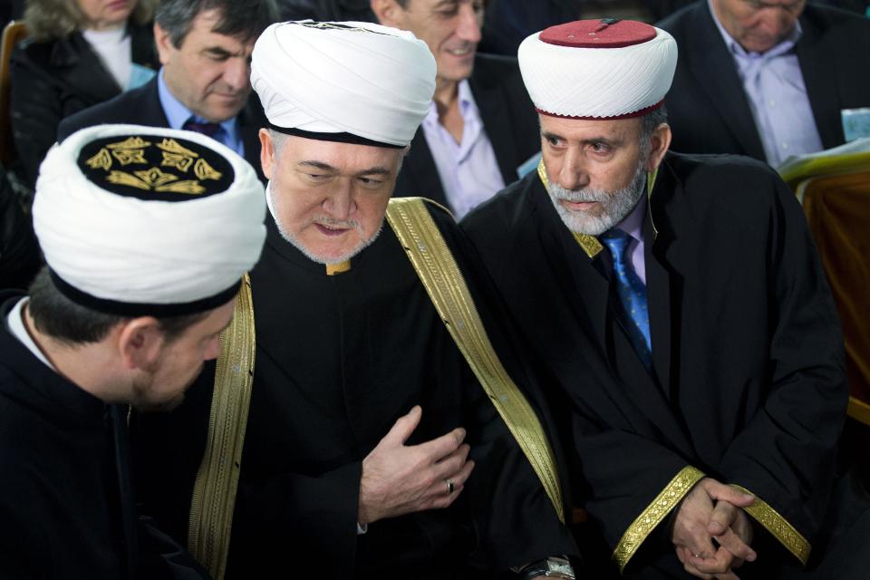 Russia's top Muslim Cleric Ravil Gainutdin, center, talks with deputy chairman of Russia Muftis Council Rushan hazrat Abbyasov, left, and Mufti of Crimean Muslims Emirali Ablayev, right, during the Crimean Tatar Qurultay, a religious congress, in Bakhchysarai, Crimea, Saturday, March 29, 2014. The Crimean Tatar Qurultay, a religious congress will determine whether the Tatars will accept Russian citizenship and the political system that comes with it, or remain Ukrainian citizens on Russian soil. (AP Photo/Pavel Golovkin)