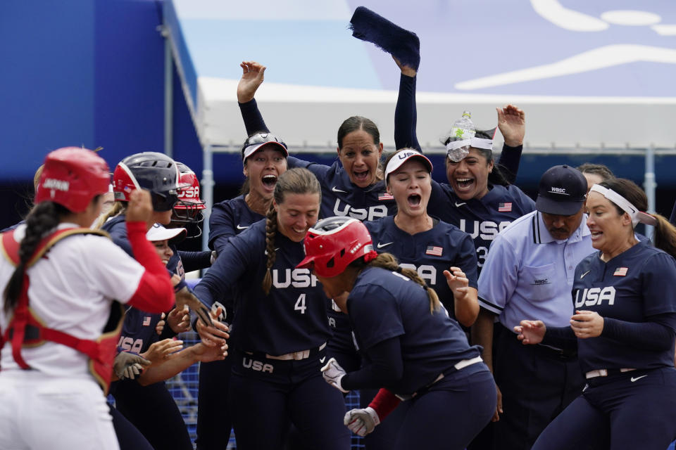 United States' Kelsey Stewart (7) is greeted at the plate by her teammates following her game winning home run against Japan in the seventh inning of a softball game at the 2020 Summer Olympics, Monday, July 26, 2021, in Yokohama, Japan. (AP Photo/Sue Ogrocki)