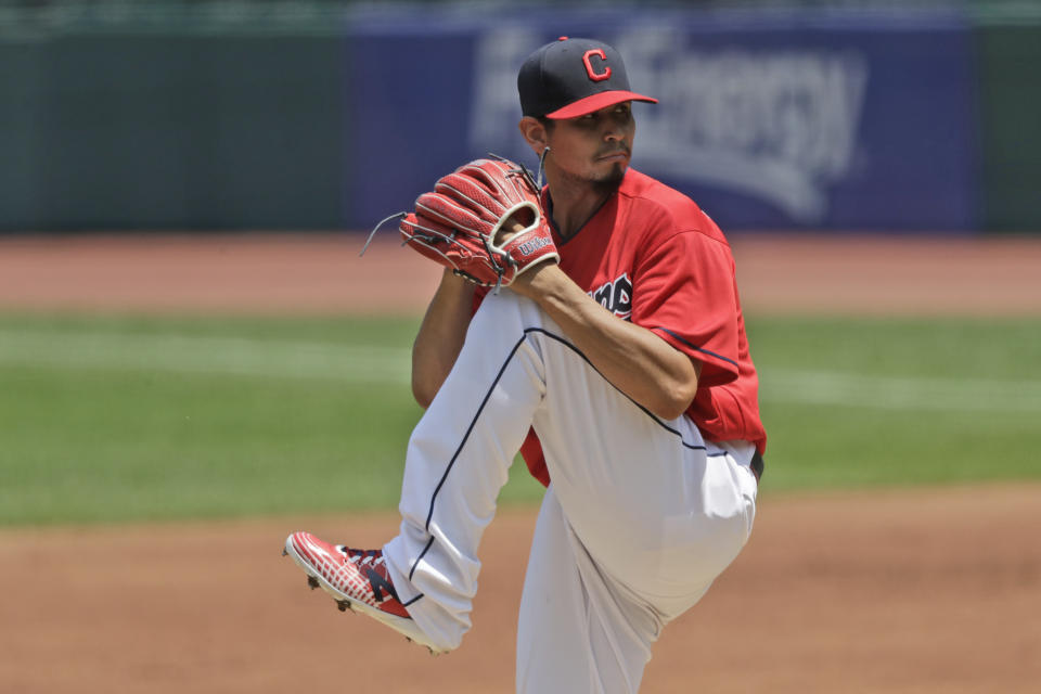 Cleveland Indians starting pitcher Carlos Carrasco winds up in the first inning in a baseball game against the Kansas City Royals, Sunday, July 26, 2020, in Cleveland. (AP Photo/Tony Dejak)