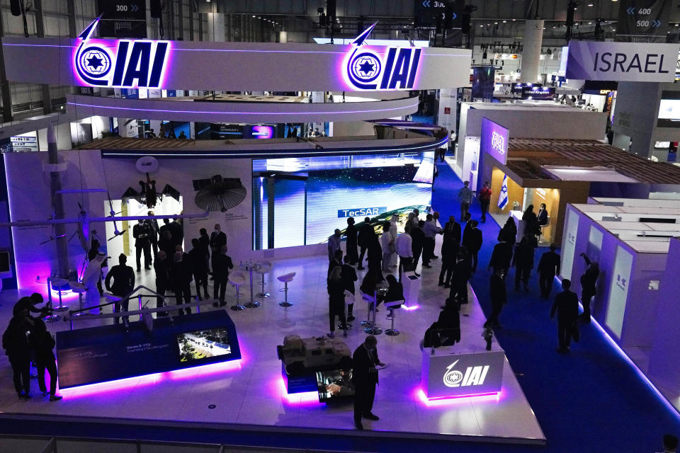 People visit the Israeli stand at the Dubai Air Show in Dubai, United Arab Emirates, Sunday, Nov. 14, 2021. The biennial Dubai Air Show opened Sunday as commercial aviation tries to shake off the coronavirus pandemic. (AP Photo/Jon Gambrell)