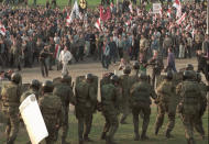 FILE In this file photo taken on Friday, April 26, 1996, demonstrators throw stones at police officers during an unauthorized rally in Minsk, Belarus. Belarus’ authoritarian President Alexander Lukashenko faces a perfect storm as he seeks a sixth term in the election held Sunday, Aug. 9, 2020 after 26 years in office. Mounting public discontent over the worsening economy and his government’s bungled handling of the coronavirus pandemic has fueled the largest opposition rallies since the Soviet collapse. (AP Photo, File)