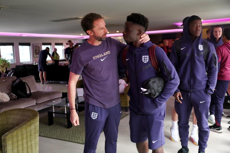 Gareth Southgate, Manager of England men's senior team, and Bukayo Saka  interact (The FA via Getty Images)