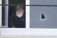 A police investigator works at the scene after a school shooting on Tuesday in Kazan, Russia, Wednesday, May 12, 2021. Russian officials say a gunman attacked a school in the city of Kazan and Russian officials say several people have been killed. Officials said the dead in Tuesday's shooting include students, a teacher and a school worker. Authorities also say over 20 others have been hospitalised with wounds. (AP Photo/Dmitri Lovetsky)