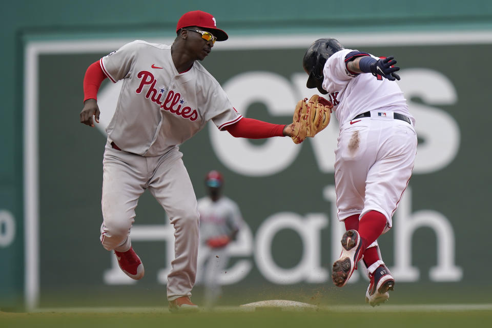 Philadelphia Phillies' Didi Gregorius, left, tags out Boston Red Sox's Christian Vazquez, right, in the sixth inning of a baseball game, Sunday, July 11, 2021, in Boston. (AP Photo/Steven Senne)