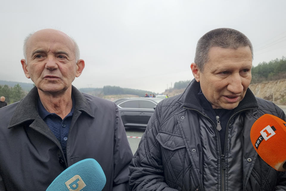 Ljubomir Joveski, left, North Macedonia's chief prosecutor and Borislav Sarafov, right, chief of Bulgaria's National Investigation Service, speak to the media at the scene of a bus crash which, according to authorities, killed at least 45 people on a highway near the village of Bosnek, western Bulgaria, Tuesday, Nov. 23, 2021. The bus, registered in Northern Macedonia, crashed around 2 a.m. and there were children among the victims, authorities said. (Konstantin Kostov/BTA Agency Bulgaria via AP)