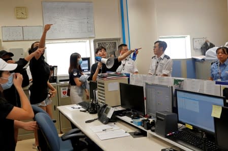 Students at Hong Kong Baptist University take part in a rally after police entered the campus on Sunday while chasing protesters, in Hong Kong