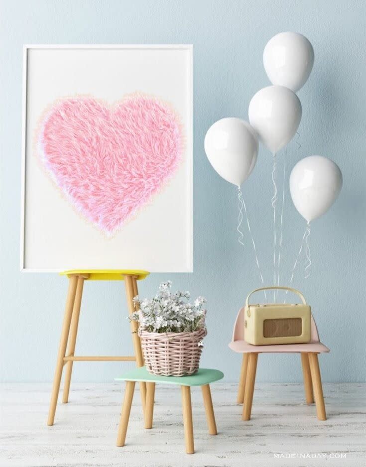 a fur heart on a display easel with other party decorations