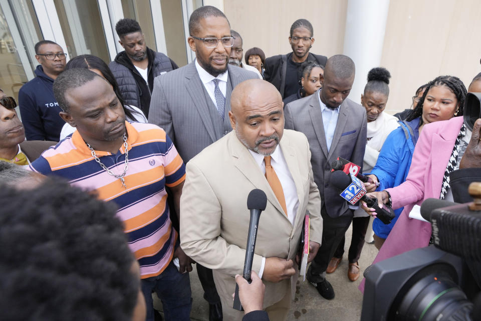 Civil co-counsel Trent Walker, center, speaks to reporters on the sentencing of the third former Rankin County law enforcement officer, while his clients, Eddie Terrell Parker, left, Michael Corey Jenkins, listen while outside the federal courthouse in Jackson, Miss., Wednesday, March 20, 2024. Former Rankin County deputy Daniel Opdyke was sentenced to 17.5 years in federal prison for his role with five other now former Rankin County law enforcement officers, in the racially motivated, violent torture of Parker and Jenkins. (AP Photo/Rogelio V. Solis)