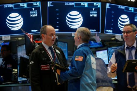 Traders work on the floor of the New York Stock Exchange (NYSE) in New York, U.S., April 18, 2018. REUTERS/Brendan McDermid