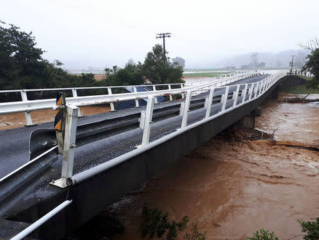 Debris is carried by a river in Bainham, New Zealand February 20, 2018 in this picture obtained from social media. Facebook/Billy Haldane/via REUTERS